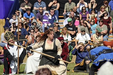 November 12,2011 - Sarasota, Florida - A peasant woman in 11th century Britian fights off a tax collector as the Bishop, Queen, King Richard II, and modern day crowd watch during 2011 Sarasota Medieval Fair, November 12-13 and 19 - 20. .のeditorial素材