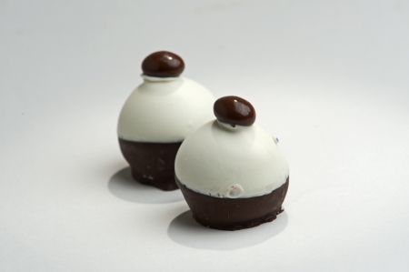 Two truffle candies with chocolate shell over soft chocolate centers.の写真素材