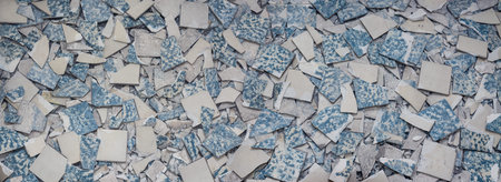 Texture from broken tiles. Background from fragments of old broken retro floor. Concept for renovation and modernization of floors and tiling.の写真素材