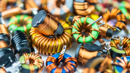 Colorful coils with magnetic core and copper winding. Beautiful background from inductors with small depth of sharpness. Concept for research, development, science and technology.の写真素材