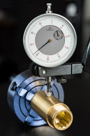 Measurement of permissible tolerance of the brass workpiece clamped in the chuck. Gold fitting and...