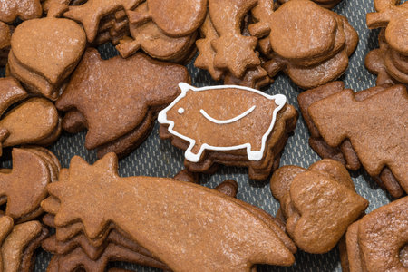 Cute New Year piggy for good luck from Christmas gingerbread. Piles of differently shaped pastries...