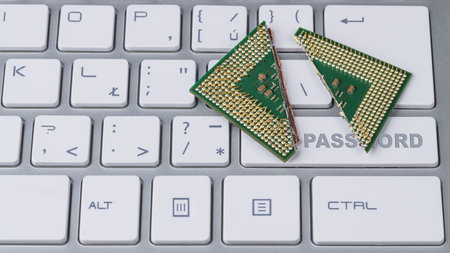Destroyed modern processor with critical security flaw. Broken CPU on computer keyboard detail....