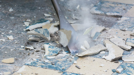 Removal of old floor during a renovation of housing. Idea of manual work. Close-up of a chisel from...