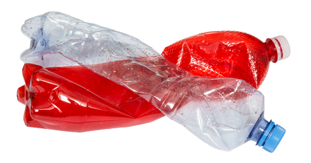Used plastic bottles in red and blue color. Two empty beverage packages isolated on white background. The idea of waste sorting, recycling and environmental pollution.の写真素材