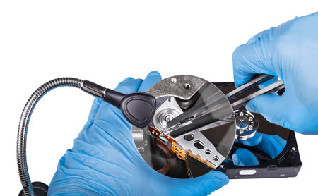 Fix of hard disk drive. Diagnostics close-up. Hands in blue gloves. Zoom of data recovery by...