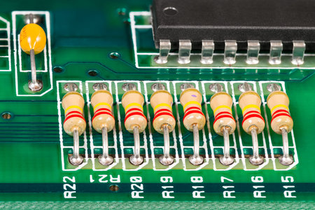 Integrated circuit, resistors and capacitor soldered on PCB. Electronic components with standard...