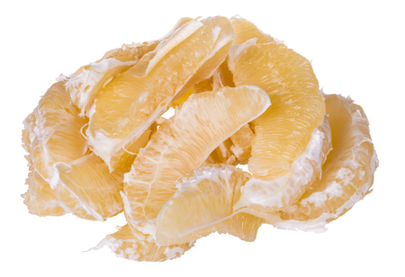 Grapefruit segments. Citrus. Peeled pomelo split into pieces. Isolated on white background. Pile of delicious sweet and sour tropical fruit divided to parts. Healthy vegetarian snack with juicy pulp.の写真素材