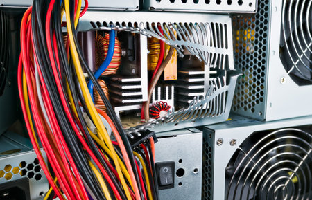 Inside of power supply unit with induction coils, heatsinks and transformer. Closeup of broken box...