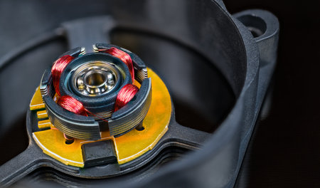 Electric motor rotor with permanent magnet, copper wire inductors and metal ball bearing. Close-up...