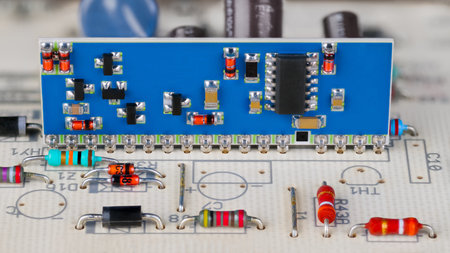 Integrated circuit and electronic components on blue PCB. Closeup a hybrid module in white printed...