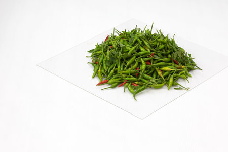 green hot chilli peppers on grey background