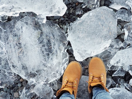Wearing snow shoes and standing on the clear big ice in Icelandの写真素材