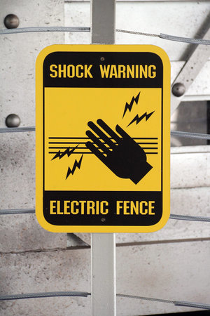 Shock warning sign at electric fence. Yellow and blackの写真素材