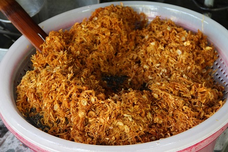 Fried shredded pork in process after fried in the large pan and before pack into a pouchの写真素材