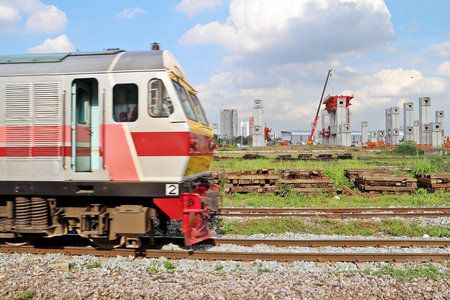 Blurred old style train going to pass and seeing clearly  construction site of new railway, the...