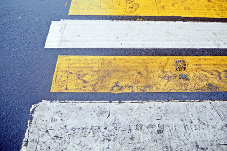 White and yellow strips on the road for people to cross the road