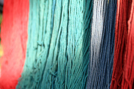 Red blue green rope dye with sun light above half. Foreground focusの写真素材