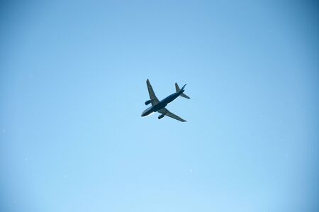 plane against the blue skyの写真素材