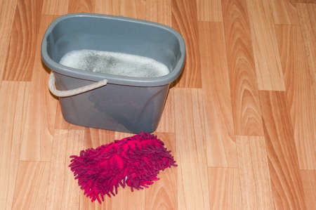 next to the gray bucket is a red rag. tidying up. Washing of floors.の写真素材