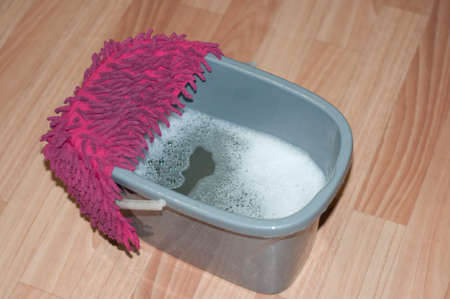 tidying up. Washing of floors. Grey bucket and red ragの写真素材