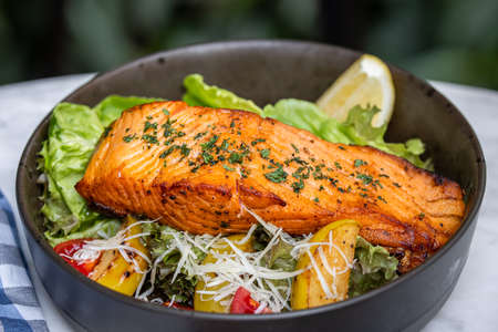 Grilled salmon fish with lemon and vegetables mixの写真素材