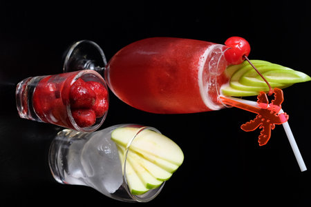 Glasses of fresh fruit cocktails on black background, close-upの写真素材