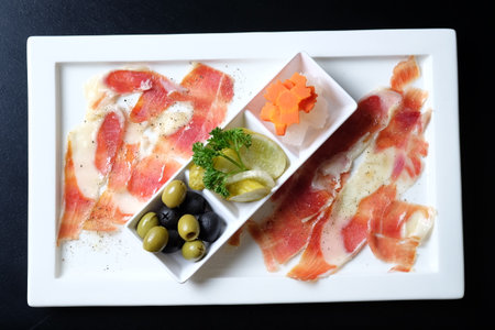 Slices of olives on white plateの写真素材