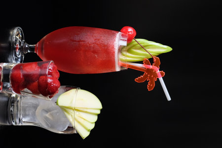 Strawberry and apple smoothies in a glass on black backgroundの写真素材