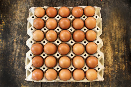 Close up of eggs in a basket. top view of eggs in bowl. Brown eggs in wooden bowl.