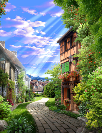 Old green alley with flowers and a stone roadの写真素材