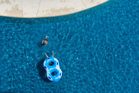 kids having fun in swimming pool with the float