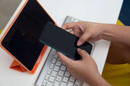 Female hands texting on smart phoneの写真素材