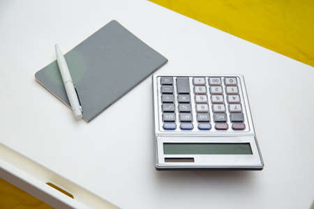 working from home concept. Notebook , pen, calculator on the table on the sofa at homeの写真素材