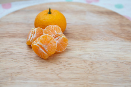 Fresh juicy clementine mandarins on wooden boardの写真素材