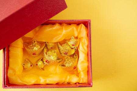 Lunar New Year decoration with lucky gold bar isolated on yellow . Tet Holiday.Translation of text appear in image: fortune good luckの写真素材