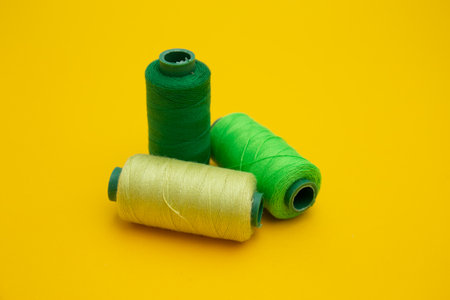 Color sewing threads on yellow backgroundの写真素材