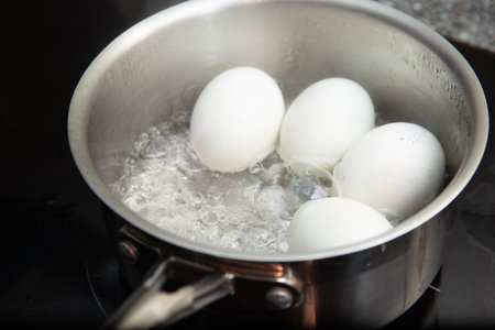 Boiled duck eggs on stove top viewの写真素材