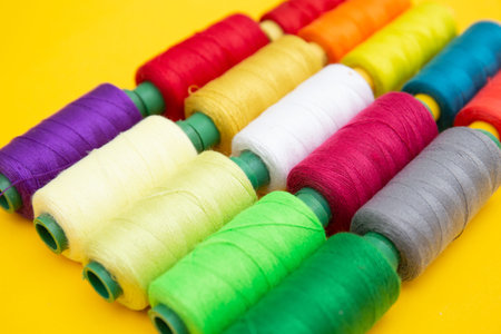 Color sewing threads on yellow backgroundの写真素材