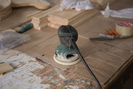 Close up shot of electric sander  on table in a carpenter workshopの写真素材