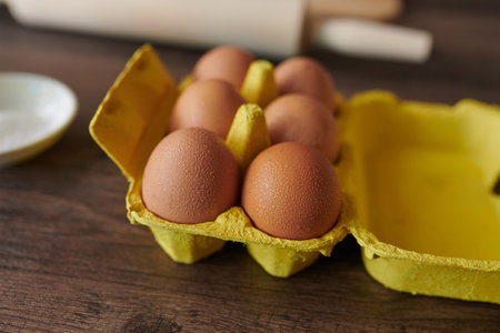 Close up shot of chicken eggs on the table with rolling pin the background for making cake