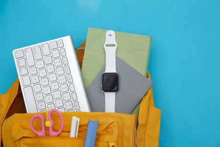 School backpack and school supplies on blue background. Back to school concept.の写真素材