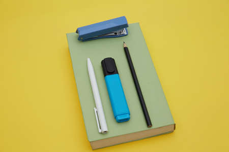 Top view of school suppliers isolated on yellow. Study concept.の写真素材