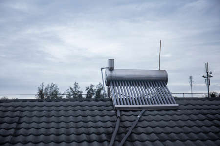 Photo of solar powered water tank heater on the rooftopの写真素材