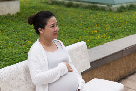 Happy Asian Pregnant Woman in the parkの写真素材