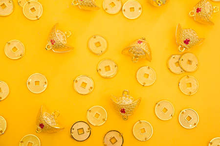 Top view of gold decorations on yellow background. Festive concept.の写真素材