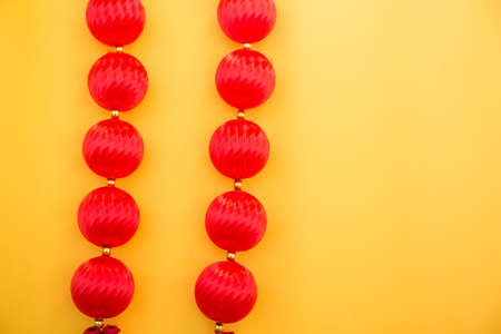 Red Chinese lanterns on yellow background. Chinese New Year concept.の写真素材
