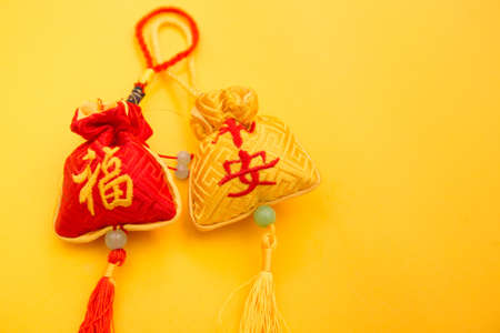 Chinese new year or lunar new year decoration on yellow background, close upの写真素材