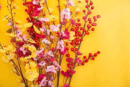 Flowers composition on yellow background. Flat lay, top view, copy spaceの写真素材