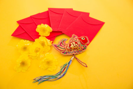 Chinese New Year Decoration, red paper lantern and gold envelopes on yellow backgroundの写真素材
